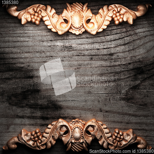 Image of golden ornament on wood