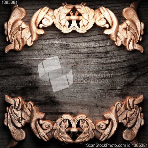 Image of golden ornament on wood