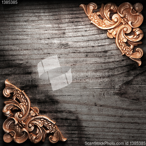 Image of golden ornament on wood