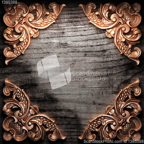 Image of golden ornament on wood