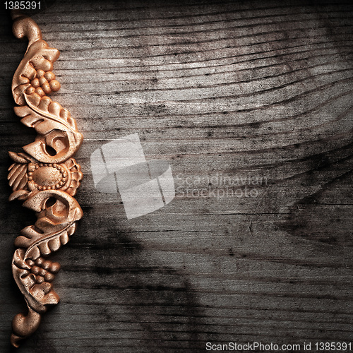 Image of golden ornament on wood