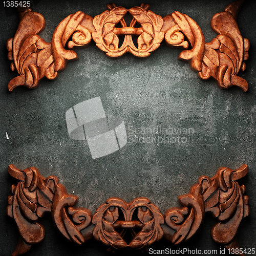 Image of red wood ornament on concrete