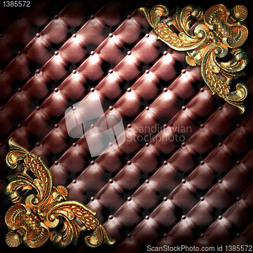 Image of golden ornament on leather