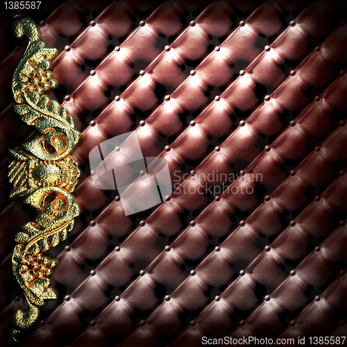 Image of golden ornament on leather