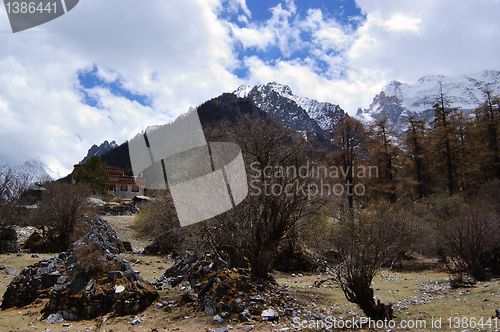 Image of Tibetan mani stones by snow mountain