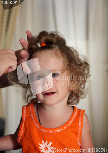 Image of combing hair little girl 