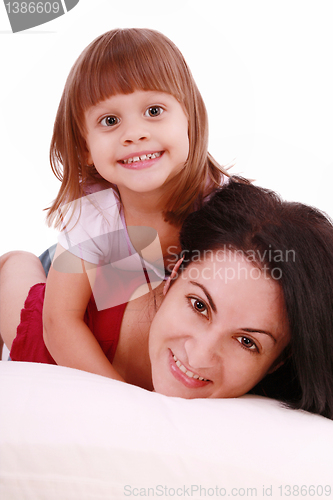 Image of A portrait of a mother and her baby girl lying on the bed and sm