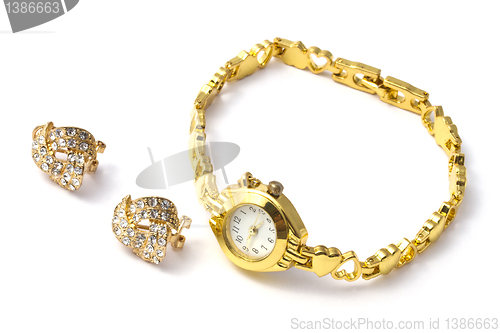 Image of golden wrist watch and earrings