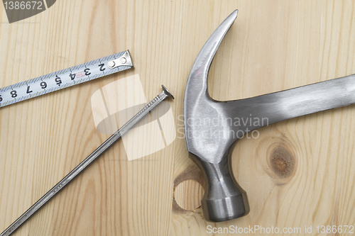 Image of Old hammer , tape measure and nail