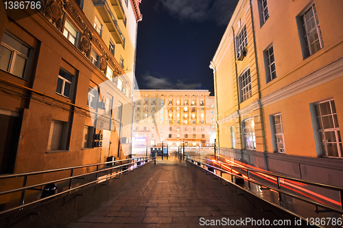 Image of night view from the court into the lighted street