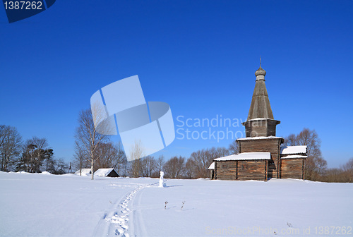Image of wooden chapel on snow field