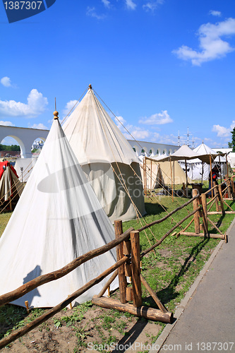 Image of white tents near ancient wall