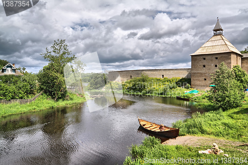 Image of wooden boat on coast river