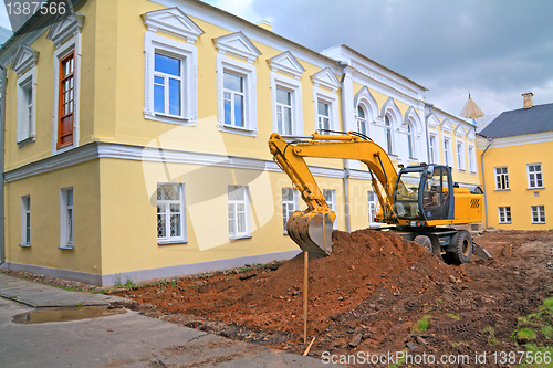 Image of excavator near townhouse