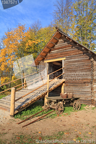 Image of aging cart near wooden barn 