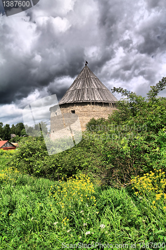 Image of tower to old fortress amongst green tree