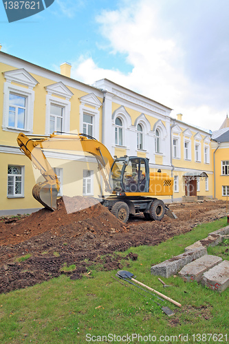 Image of excavator near townhouse