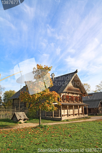 Image of yellow tree near rural building