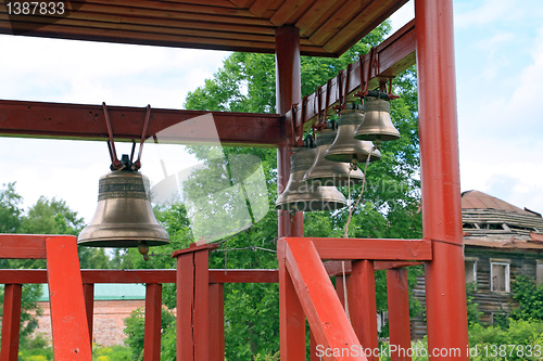 Image of small bell in wooden summerhouse