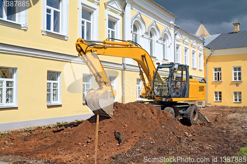 Image of excavator near townhouse