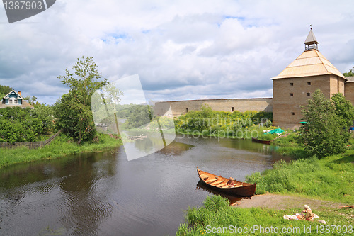 Image of wooden boat on coast river