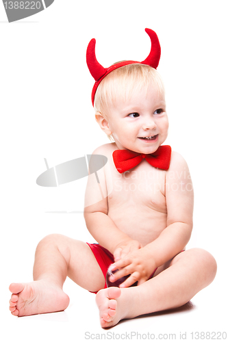 Image of kid in red suit of tempting devil 