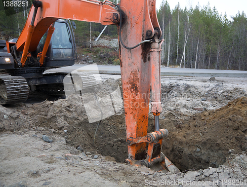 Image of Backhoe digging trench