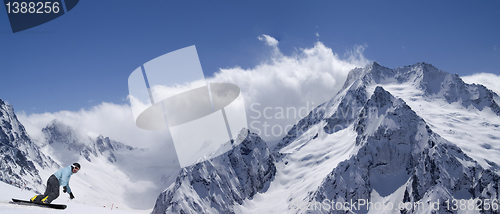 Image of Panorama snow mountains with snowboarder