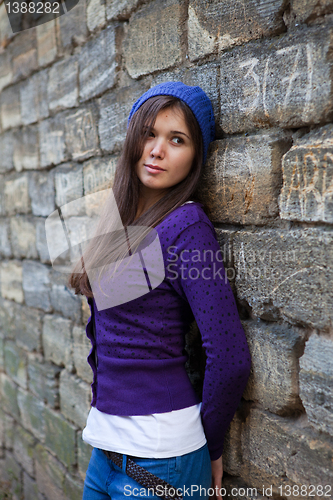 Image of Girl in lilac against the wall