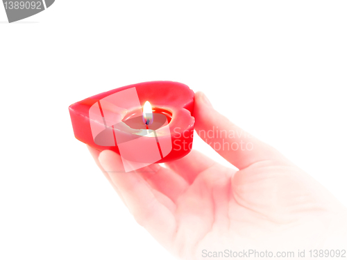 Image of candle heart in a human hand 