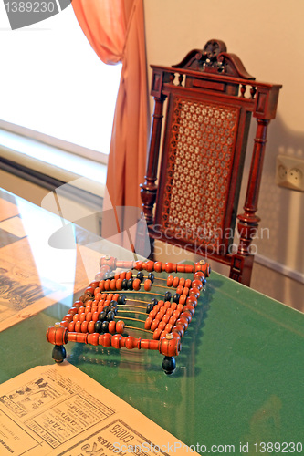Image of wooden abacus on green table