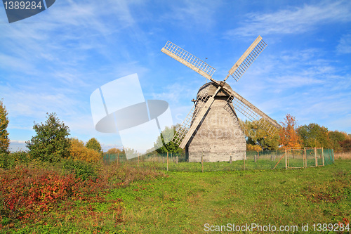 Image of aging mill on autumn meadow