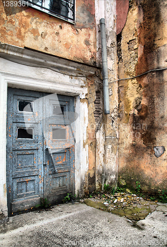 Image of aging door in destroyed building