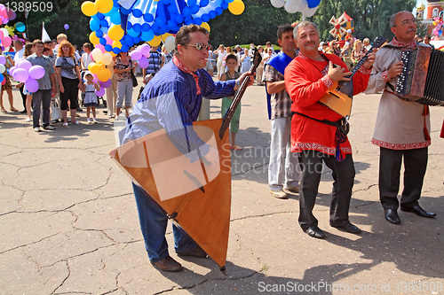 Image of Staraya Russa, Russia - July 9: Unknown man with balalaika at th