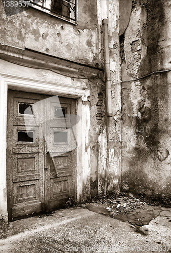 Image of aging door in destroyed building