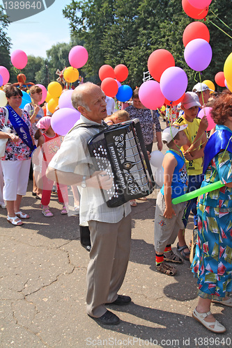 Image of Staraya Russa, Russia - July 9: Unknown man with accordeon at th