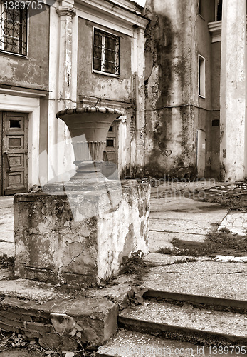 Image of decorative urn near old buildings