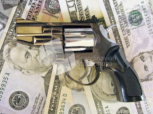 Image of gun on dollars 