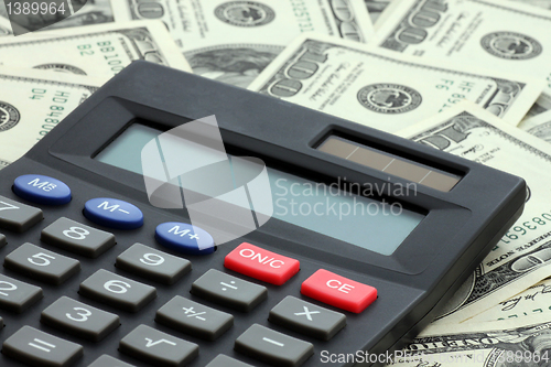 Image of calculator on dollars