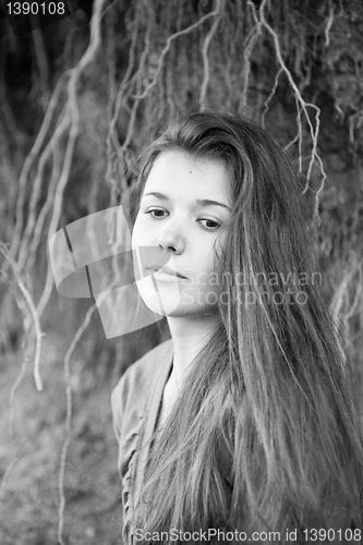 Image of Portrait of a girl with tree root on background