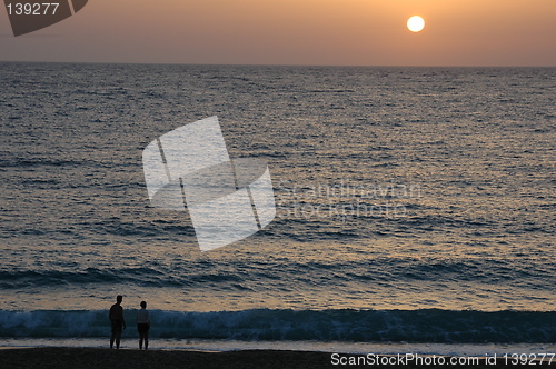 Image of Couple watching sunset