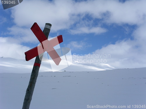 Image of Red cross sign in snowy landscape