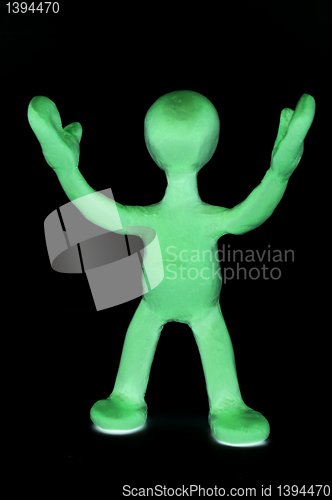 Image of Shaded puppet of plasticine signing by hands