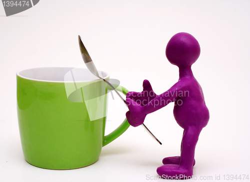 Image of Purple puppet of plasticine holding melhior spoon