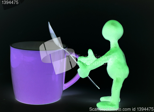 Image of Shaded puppet of plasticine holding melhior spoon