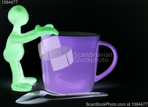 Image of Shaded puppet of plasticine rest on cup