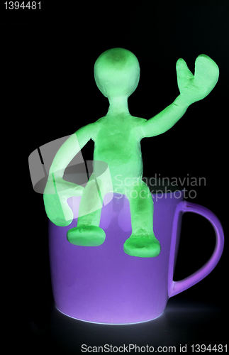 Image of Shaded puppet of plasticine sitting on cup