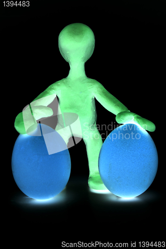 Image of Shaded puppet of plasticine holding two eggs