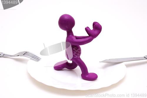 Image of Purple puppet of plasticine begging for life