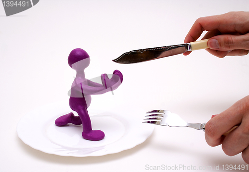 Image of Purple puppet of plasticine begging for life